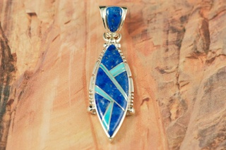 Genuine Blue Lapis inlaid between ribbons of Sterling Silver. Beautiful Fire and Ice Lab Opal Accents. Precision inlay on the bale and pendant.  Free 18